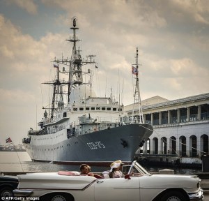 Just like old times: Tourists in a old American car pass by Russian Vishnya class warship CCB-175 Viktor Leonov, docked, on February 26, 2014, at Havana harbor (AFP/Getty Images)
