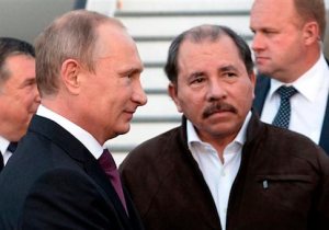 Nicaragua's President Daniel Ortega, right, and Russian President Vladimir Putin, left, attend a welcome ceremony at an airport in Managua, Nicaragua, Friday, July 11, 2014. (AP Photo/RIA-Novosti, Alexei Nikolsky, Presidential Press Service)